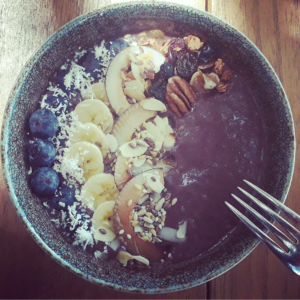 Acai bowl with vegan granola and agave nectar